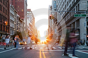 Busy street scene is crowded with people at an intersection on Fifth Avenue in New York City