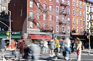 Busy street scene with crowds of people walking through the intersection on 7th Avenue and Bleecker in the Greenwich Village photo