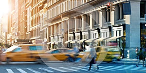 Busy street scene in Midtown Manhattan with taxis and people hurrying through the crowded intersection in New York City