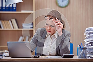 The busy stressful woman secretary under stress in the office