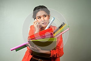 Busy Asian business woman with a lot of folders and colorful pap