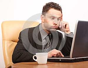 Busy time in stressful job - business man working with laptop photo