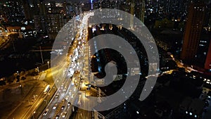 Busy urban traffic jam at night,Brightly lit urban morden building background.