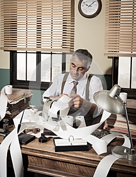 Busy vintage accountant with calculator