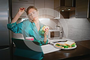 Busy woman eating, drinking coffee, talking on the phone, working on a laptop at the same time. Businesswoman doing