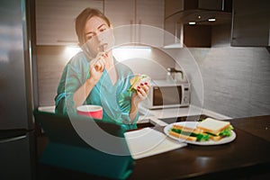 Busy woman eating, drinking coffee, talking on the phone, working on a laptop at the same time. Businesswoman doing