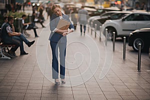 Busy woman is in a hurry, she does not have time, she is going to talk on the phone on the go. Businesswoman doing