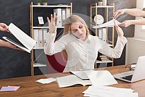 Busy woman in office gesturing stop to assistants