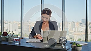 Busy woman study documents in panoramic office. Company lawyer signing papers