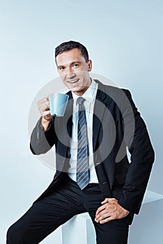 Busy working man enjoying his cup of coffee