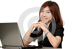 Busy young business woman working at desk typing on a laptop