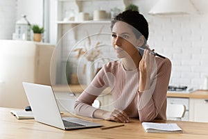 Busy young latin woman freelancer contact client using phone loudspeaker