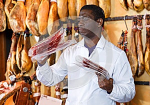 Butcher checking quality of jamon