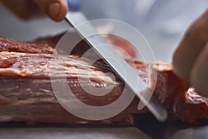 Butcher cleaning the meat from impurities