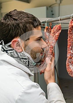 Butcher controls sausage