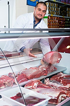 Butcher cutting fresh lamb meat