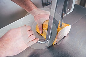 Butcher cutting meat in butchery