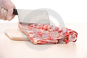 Butcher cutting meat on chopping board