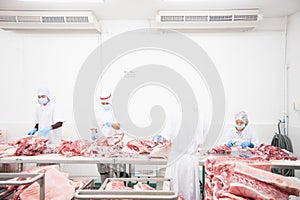 Butcher cutting meat on the table