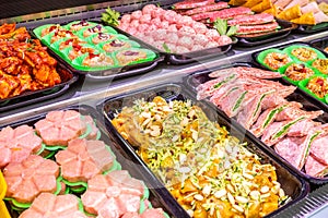 Butcher, meat department. Several products displayed in a showcase.