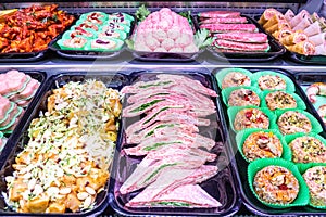 Butcher, meat department. Several products displayed in a showcase.