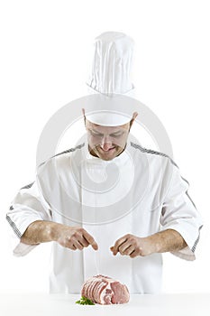 Butcher preparingng raw rolled meat enclosed