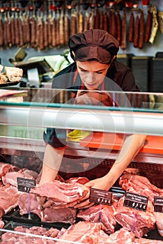 Butcher`s hands holding meat piece in shop