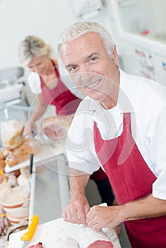 Butcher serving female customer