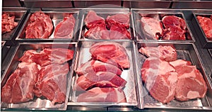 Butcher shop fridge counter with cold raw meat