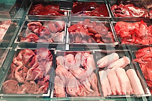 Butcher shop fridge counter with cold raw meat