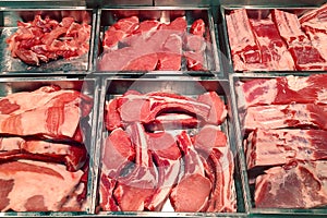 Butcher shop fridge counter with cold raw meat