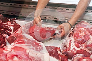 Butcher showing a piece of meat to a customer