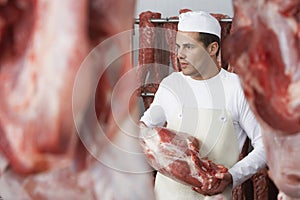 Butcher Working In Meat Locker