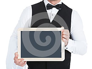 Butler holding blank slate photo