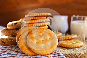 butter biscuits cracker and milk set up on napkin and wooden background