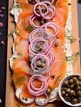 Butter board with smoked salmon, capers, red onions, spices and herbs. Starter for party, finger food. Top view. Trendy food