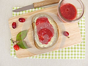 Butter bread with cornelian cherry jam for breakfast