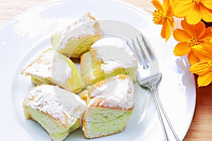 Butter bread of dish on the wooden table and flower.