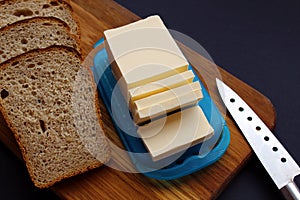 Butter and bread sliced on the board