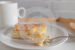 Butter cake with almond, sugar topping. Traditional german yeast cake served on a plate