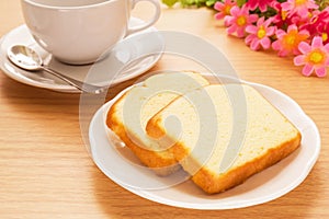 Butter cake sliced on plate and coffee cup, filtered image