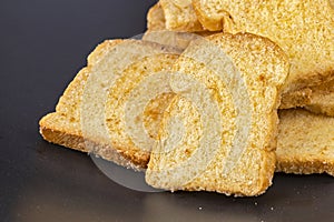 Butter crispy bread topping sugar on black plate