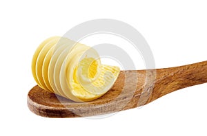 Butter curl on a wooden spoon