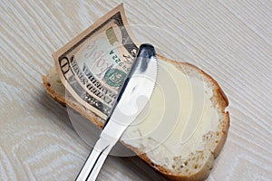 Butter and money on a slice of bread