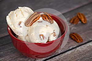 Butter pecan ice cream in a red bowl