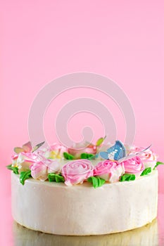 Butter cream of Pink Roses decorated oo vanilla pond cake on pink background with copy space served in Birthday Party and wedding