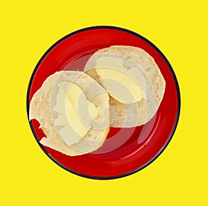 Buttered biscuit on a red dish