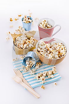 Buttered popcorn in bowls over white background