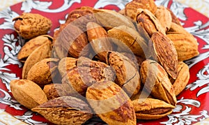 Buttered roast almond with hard shell on plate