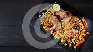 Butterflied grilled whole chicken with roasted vegetables and potatoes